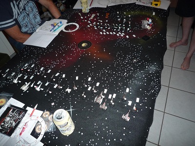 Two fleets of Imperial and Zhodani starship miniatures, with movement markers laid out on a starfield battlemat
